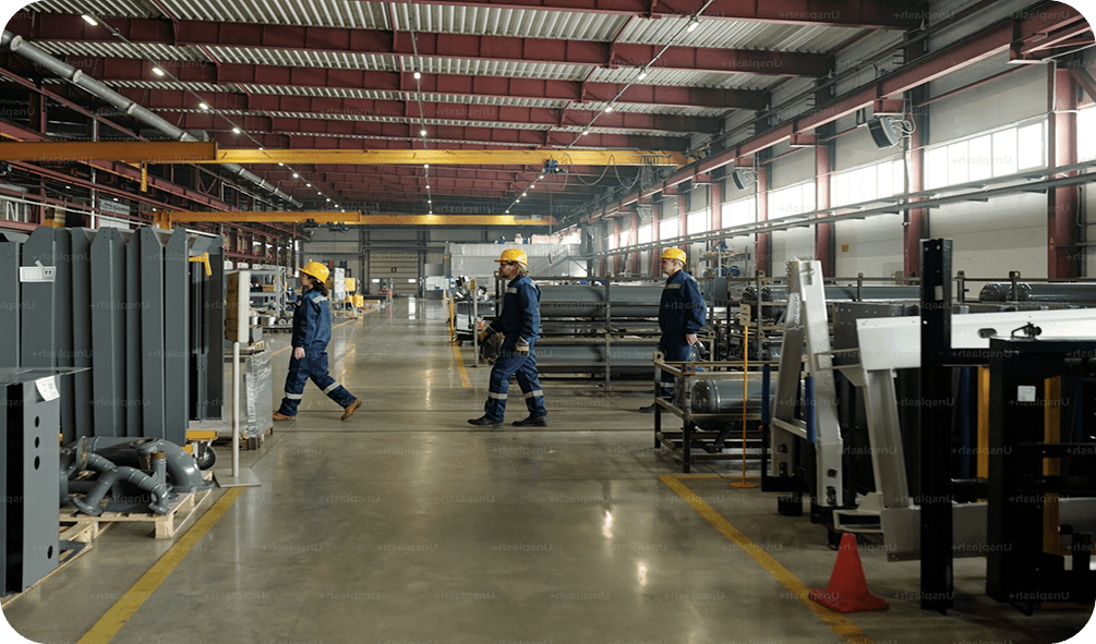 Engineer with a tablet outside a modern manufacturing plant