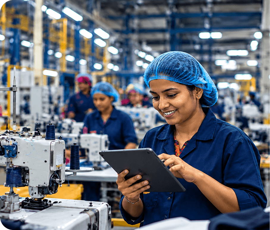 Factory worker checking alerts on a tablet on the production floor